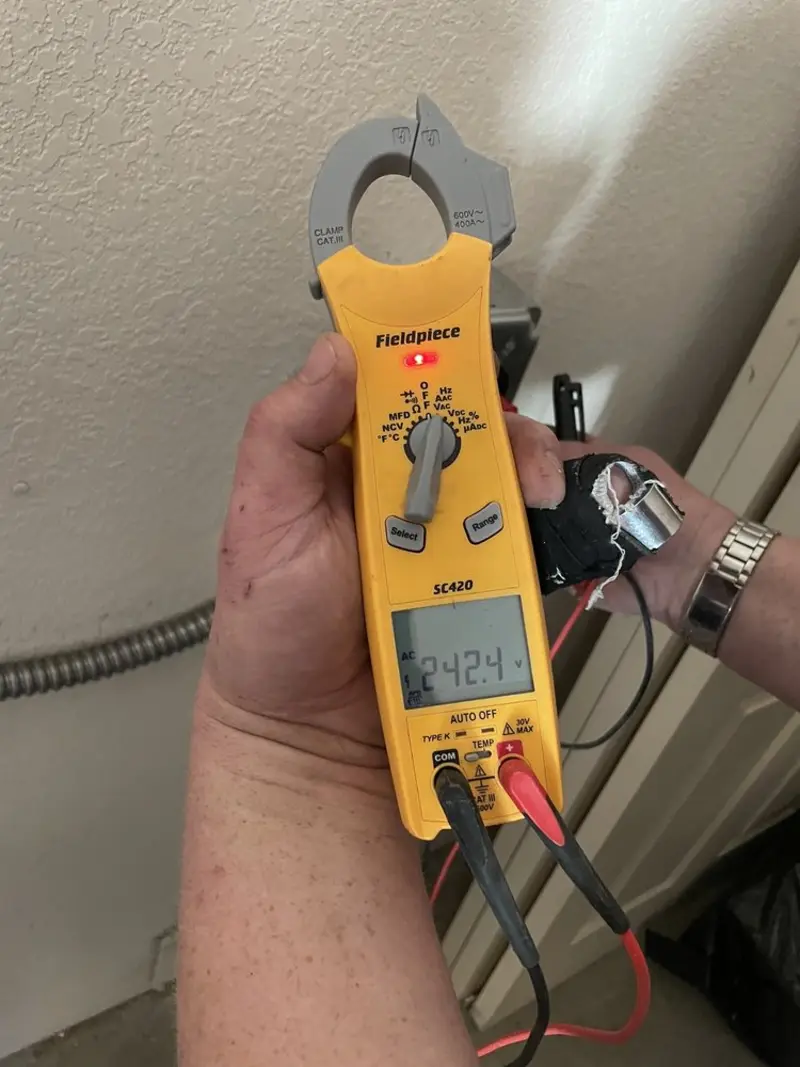 Voltage testing with clamp meter during Whole House Surge Protector in Genesee